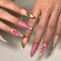 Handmade gold floral French tips press-on nails with pink flowers and accent designs