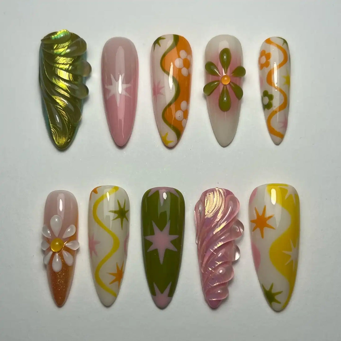 Handmade press-on nails with groovy retro designs in pink, orange, green, and floral patterns.