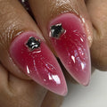 Handmade press-on nails with red ombre, glitter, and black star chrome accents