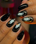 Handmade black press-on nails with cute Halloween ghost and metallic accent designs