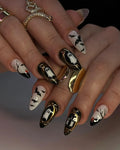 Handmade Halloween press-on nails with ghost, bat, and gold frame designs on almond tips
