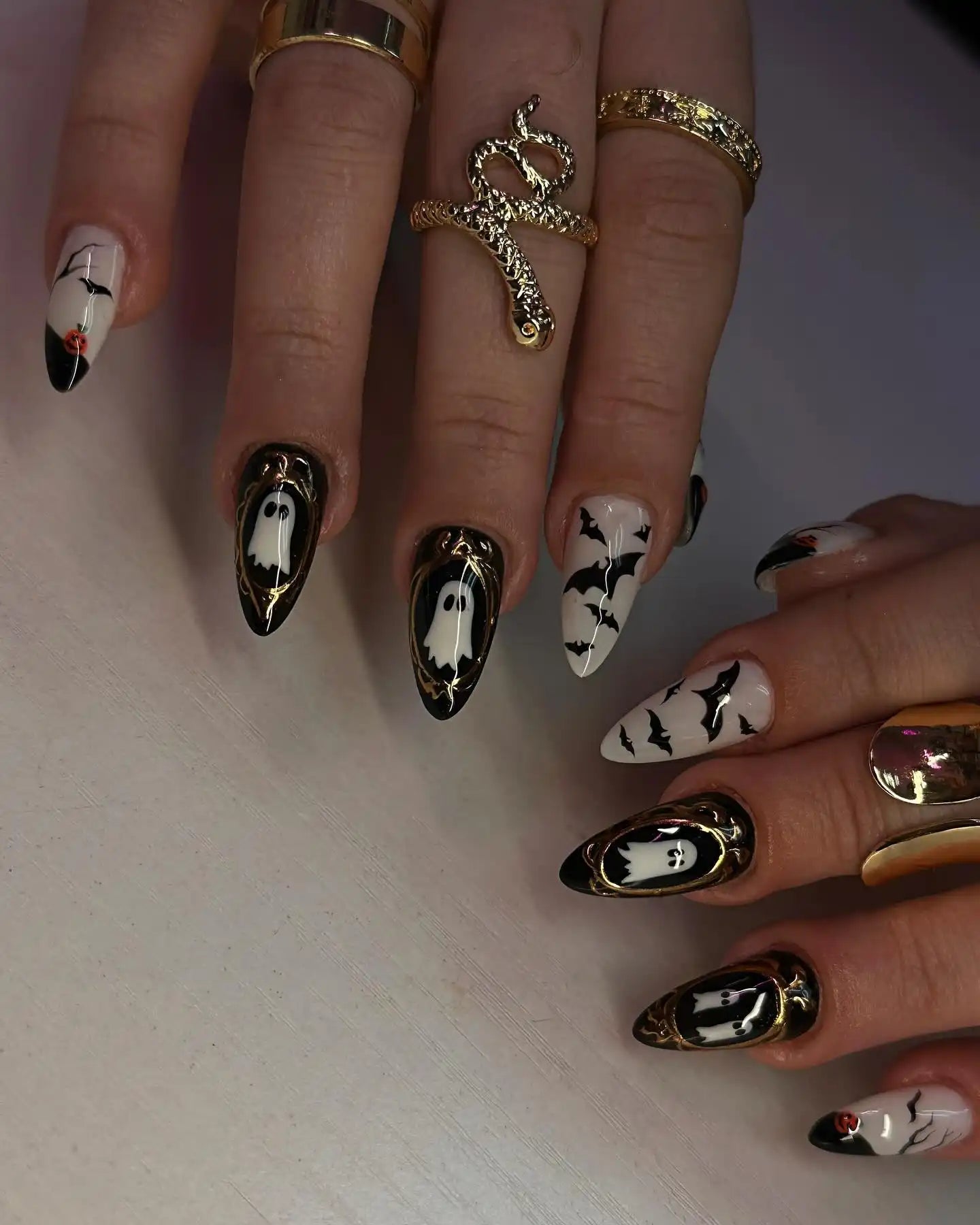 Handmade Halloween press-on nails with ghost, bat designs and gold frame accents