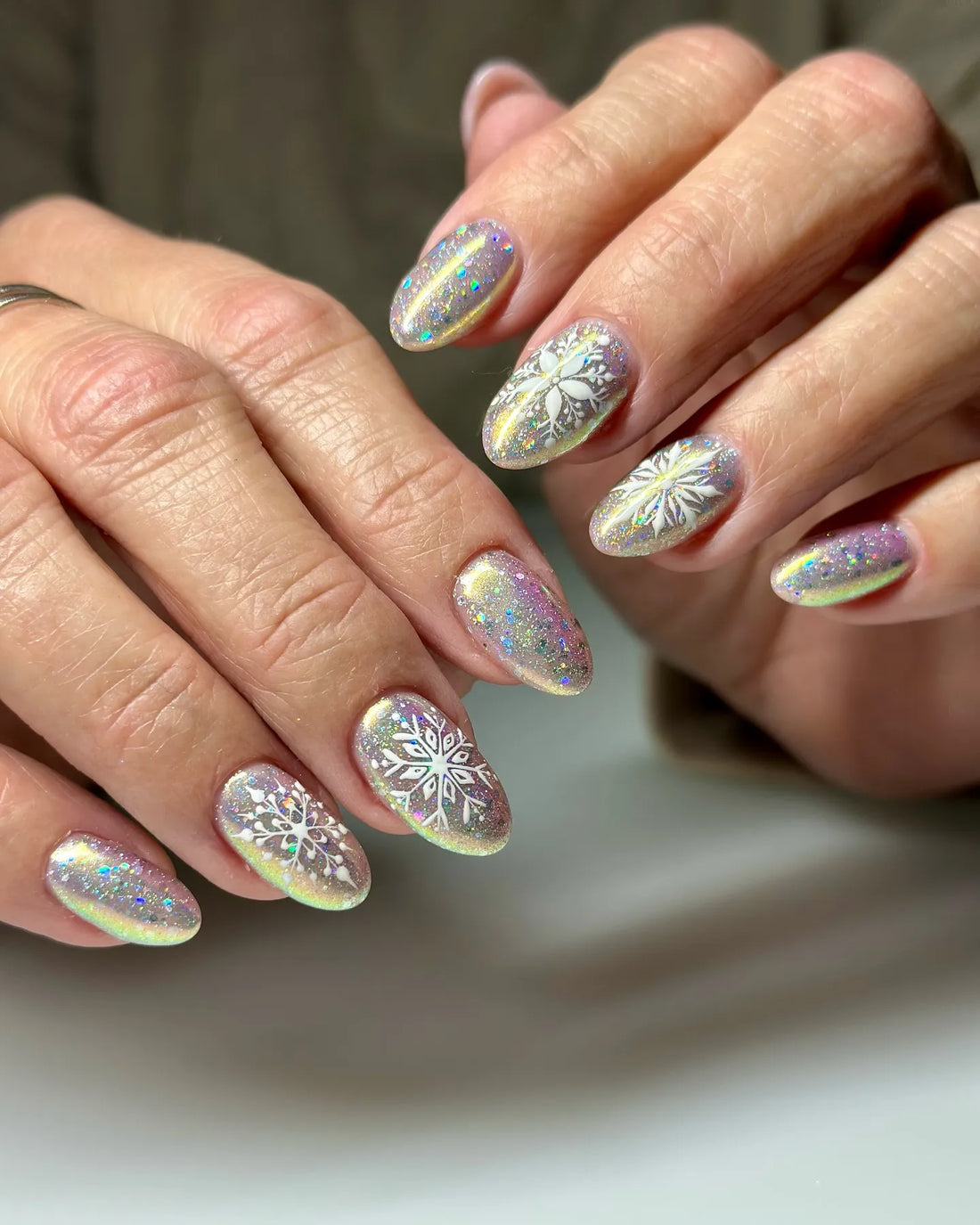 Handmade holographic glitter press-on nails with chrome snowflake winter designs