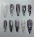 Handmade iridescent chrome purple abstract press-on nails with heart and metallic swirl designs