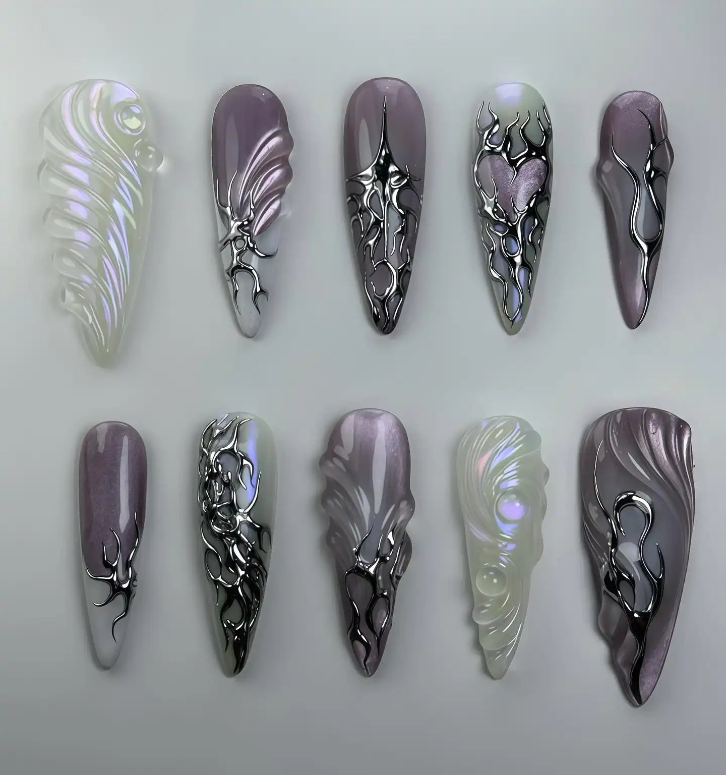 Handmade iridescent chrome purple abstract press-on nails with heart and metallic swirl designs
