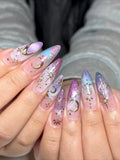 Handmade iridescent stiletto press-on nails with golden moon and star celestial designs