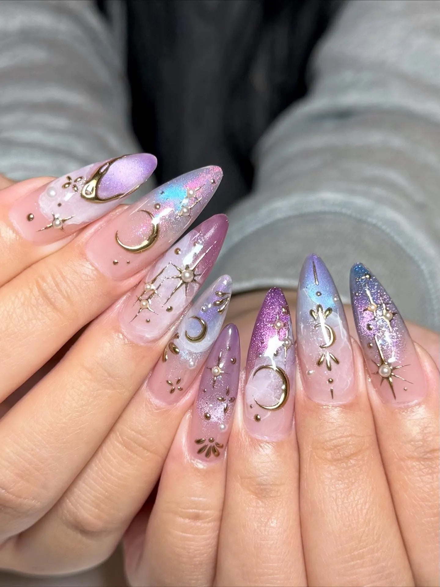 Handmade iridescent stiletto press-on nails with golden moon and star celestial designs