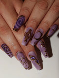 Handmade lavender press-on nails with gold celestial moon, sun, and star designs