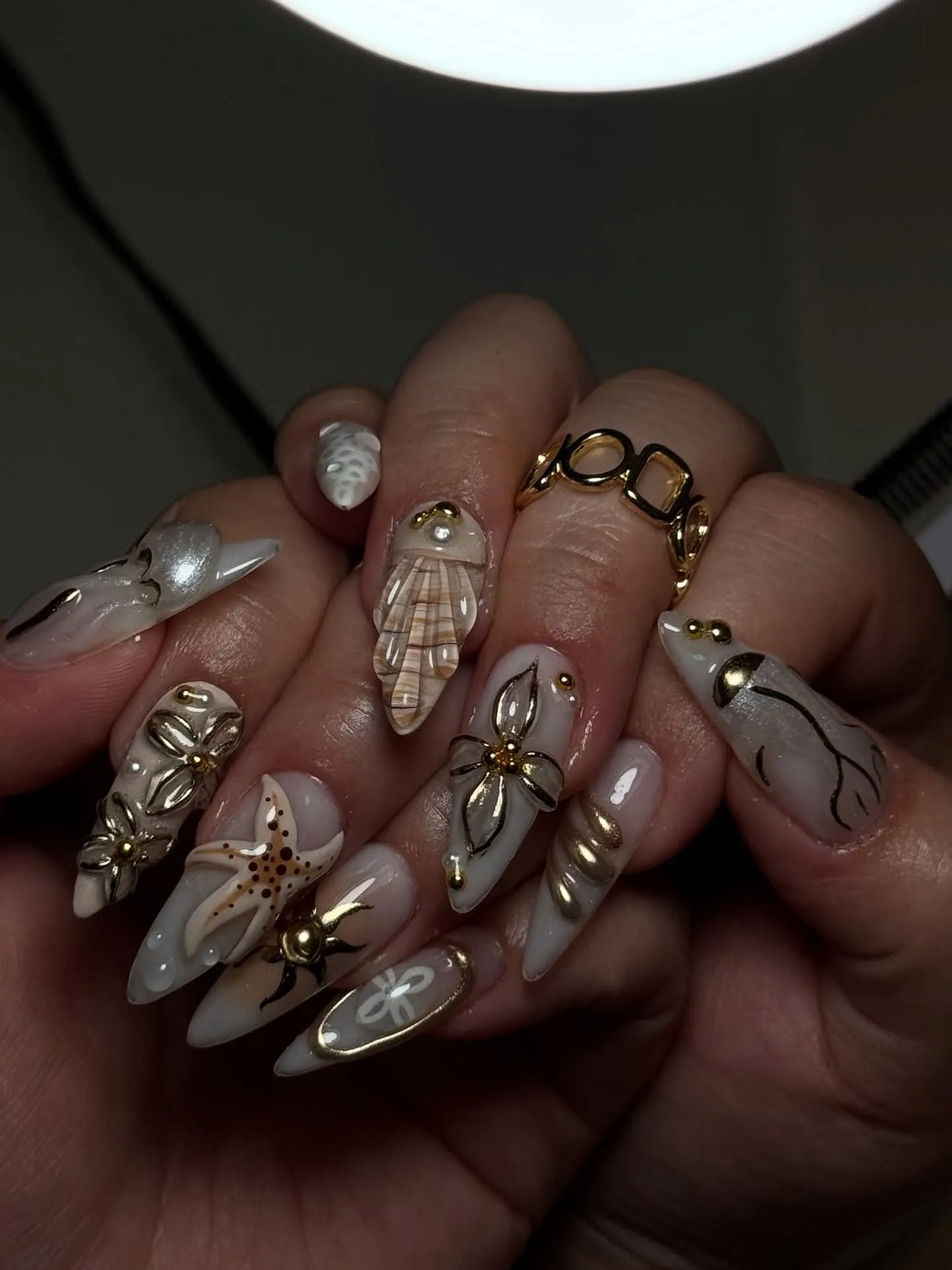 Handmade coastal press-on nails with 3D starfish, seashell, and pearl decorations