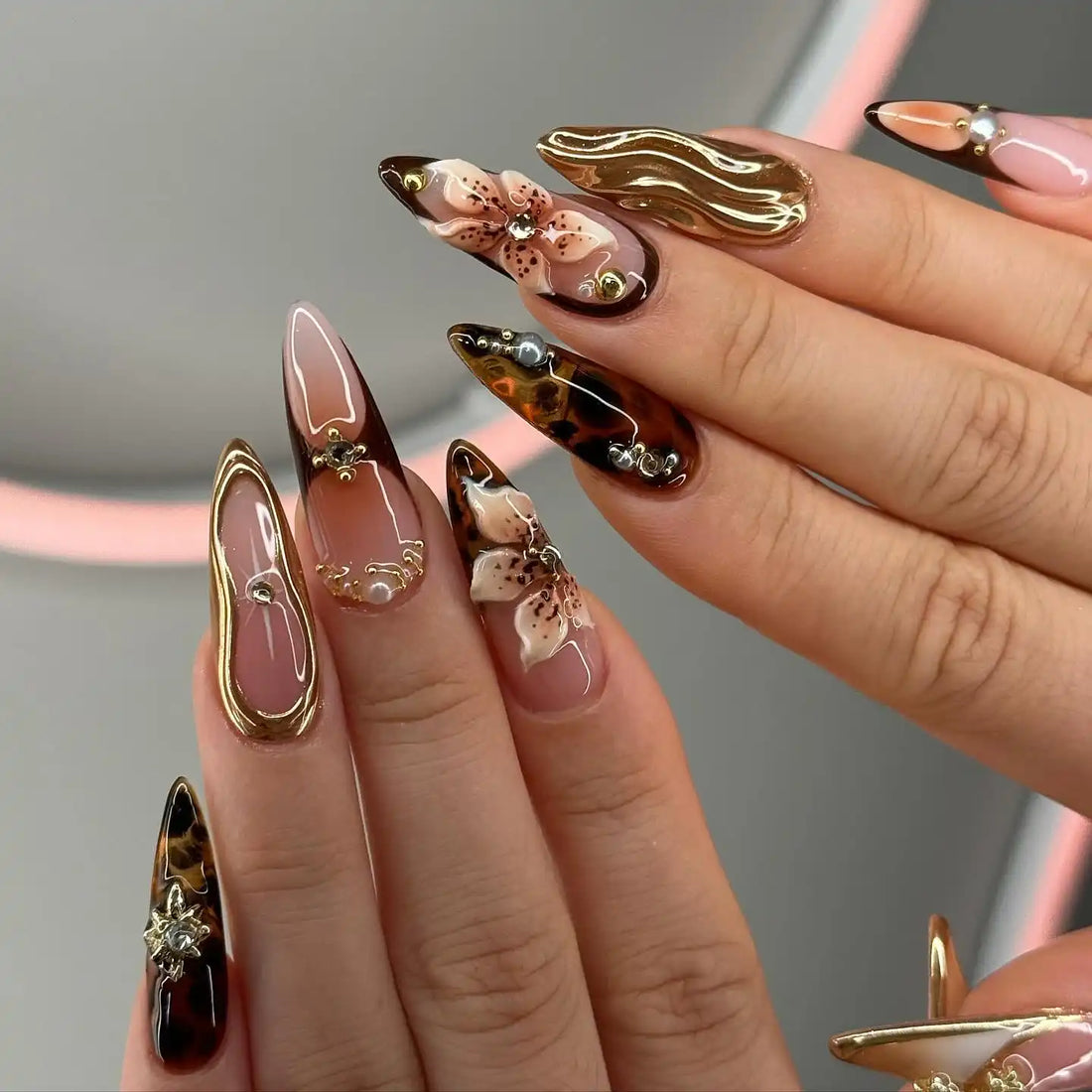 Handmade luxury 3D floral press-on nails with gold accents, pearls, and tortoiseshell tips