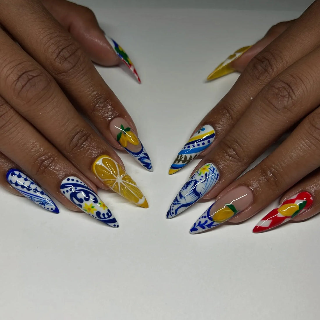 Handmade Mediterranean stiletto press-on nails with blue, white, and lemon designs