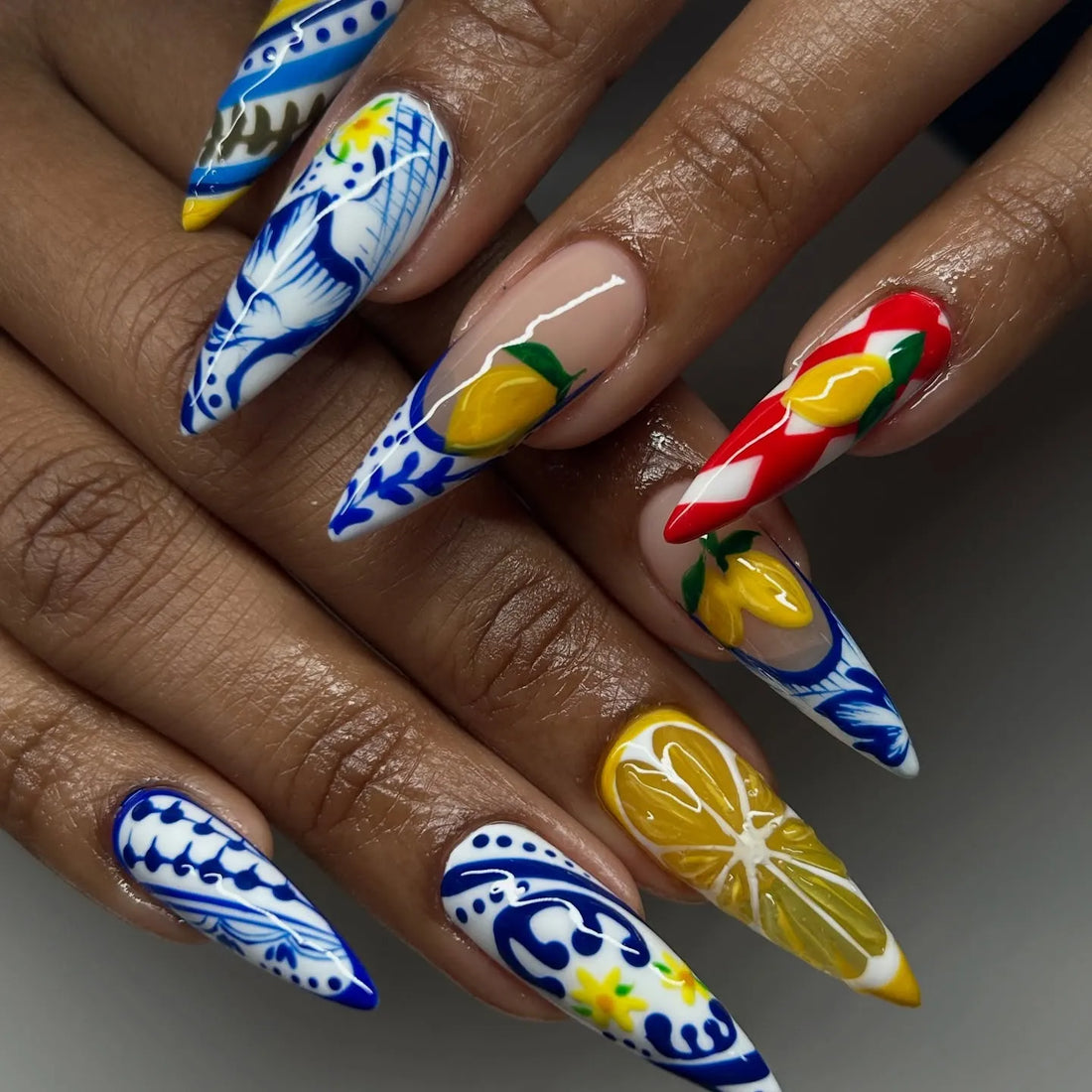 Handmade Mediterranean stiletto press-on nails with blue, white, and lemon designs