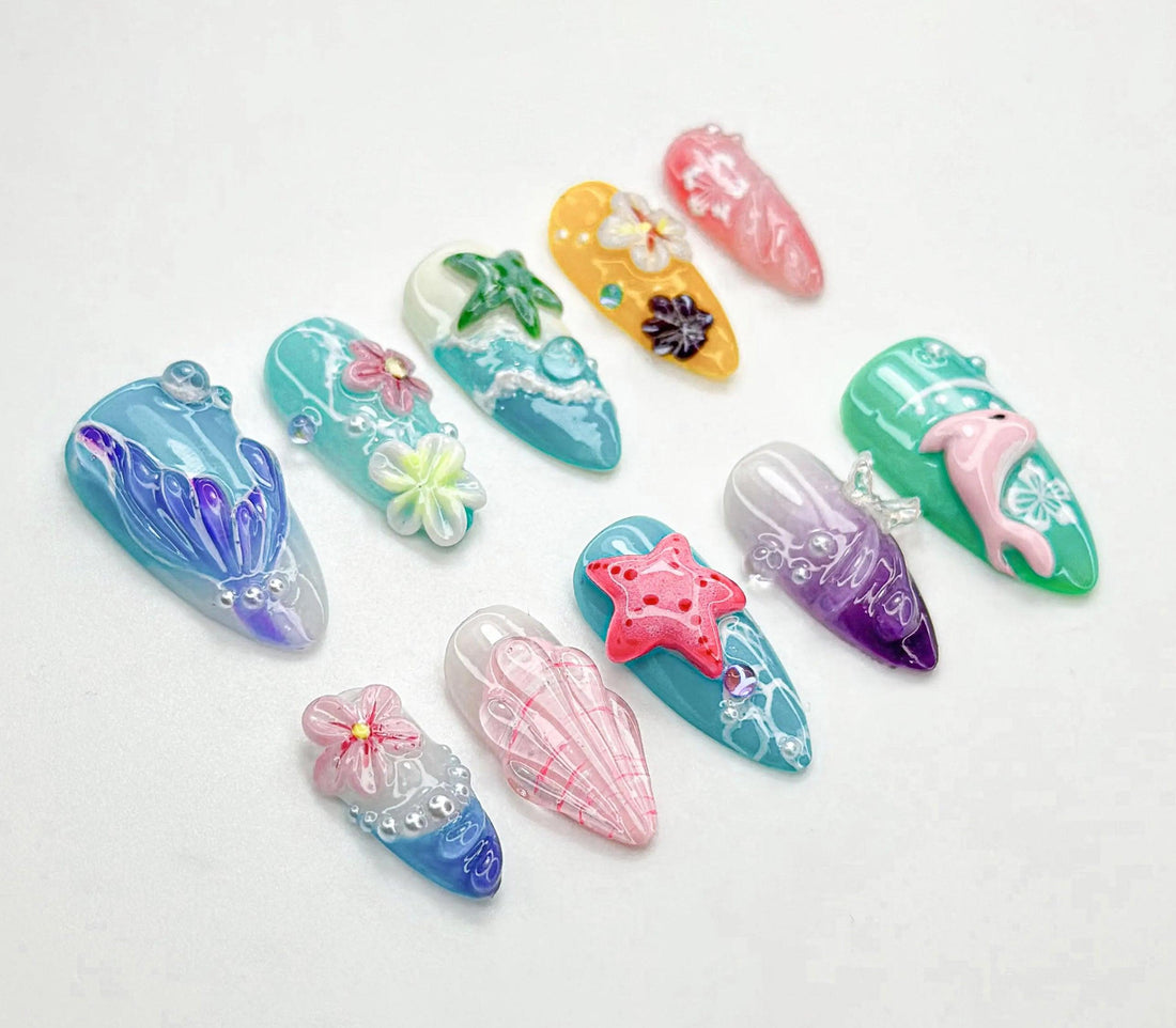 Handmade summer ocean-themed press-on nails with 3D starfish, flowers, seashell, and dolphin designs.