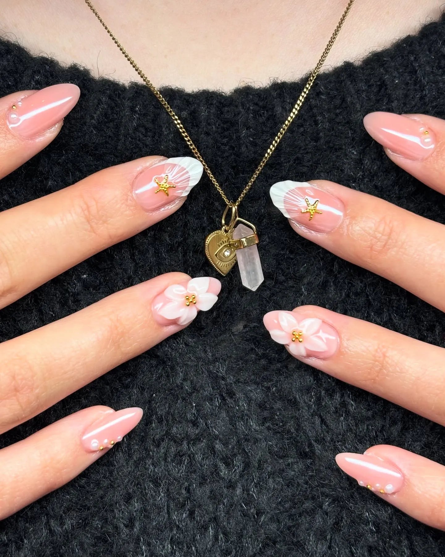 Handmade press-on nails with pink base, 3D white flowers, gold star accents, and pearl details