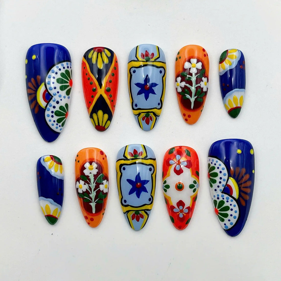 Handmade vibrant Mexican Talavera tile press-on nails with floral patterns and bold colors