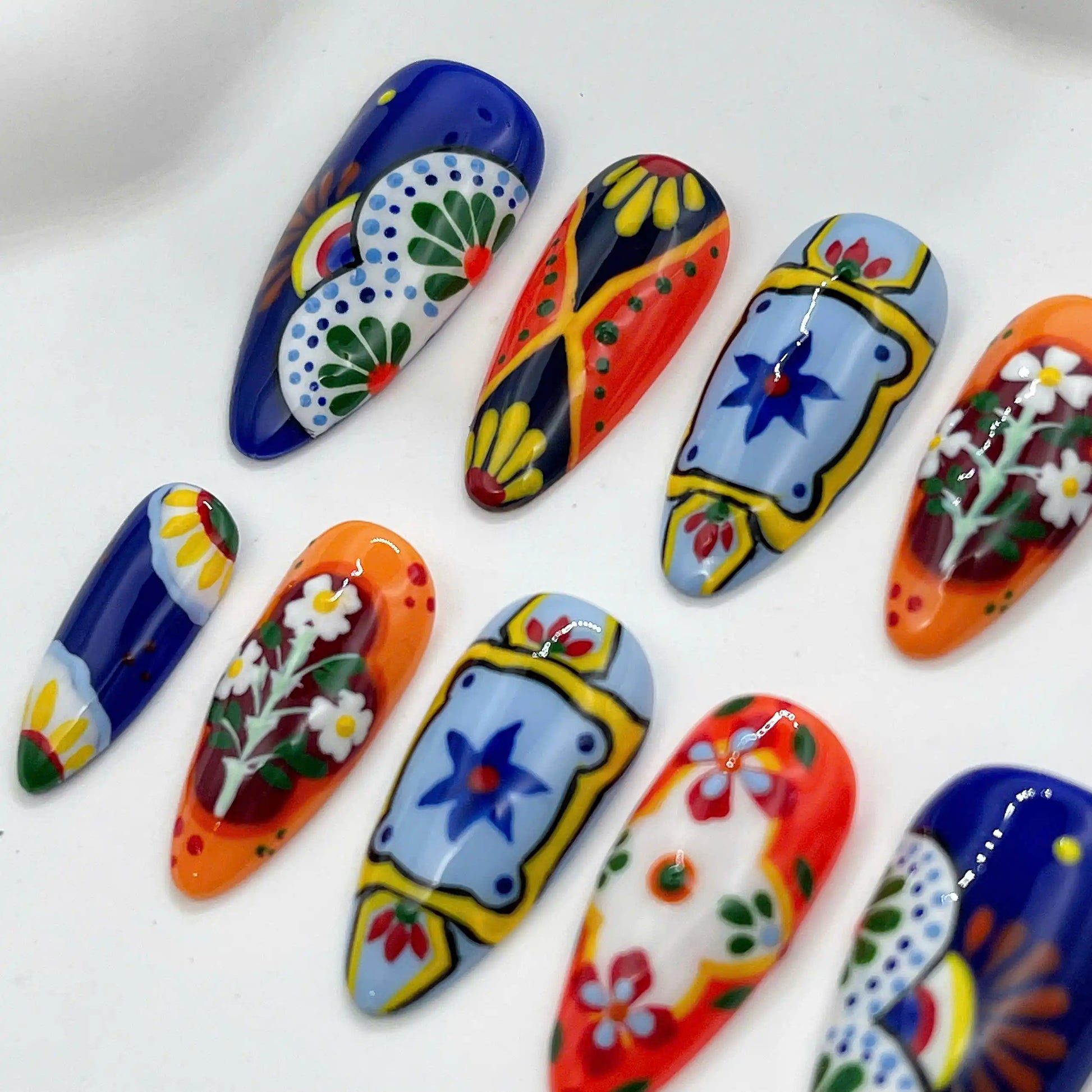 Handmade press-on nails with vibrant Mexican Talavera tile floral designs