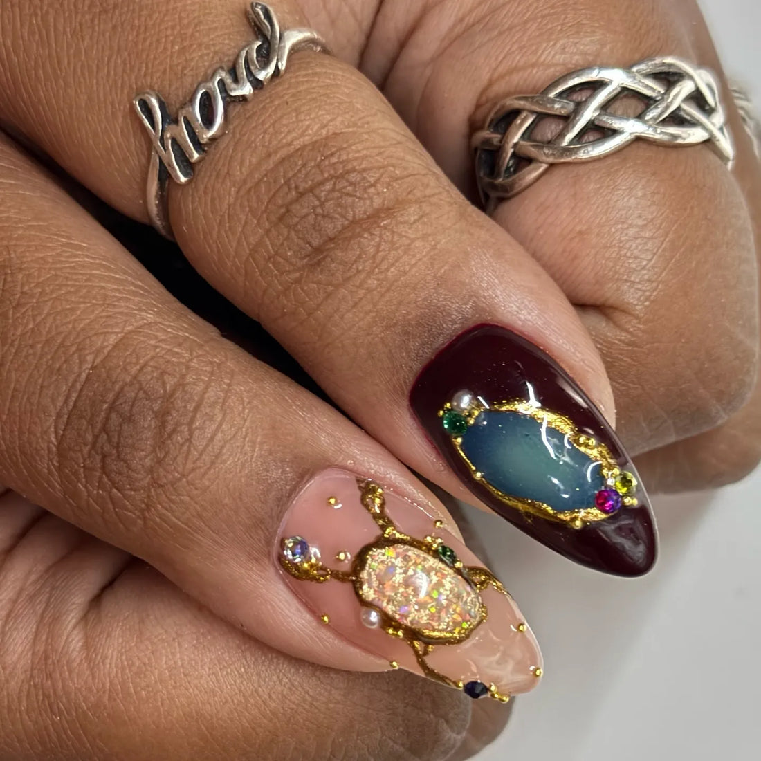 Handmade press-on nails with monarch butterfly, crystal jewel, and gold art details.