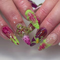 Handmade press-on nails with neon green, pink, and purple abstract drip designs, 3D flower and frog accents