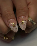 Handmade press-on nails with nude and soft smoke marbling, gold celestial heart charm accents