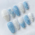 Handmade press-on nails with ocean blue jellyfish, pearls, and seashell art designs.