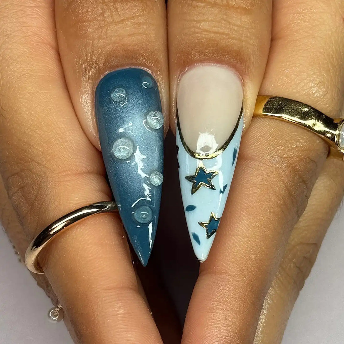 Handmade ocean blue ombre press-on nails with 3D floral, butterfly, and sky designs