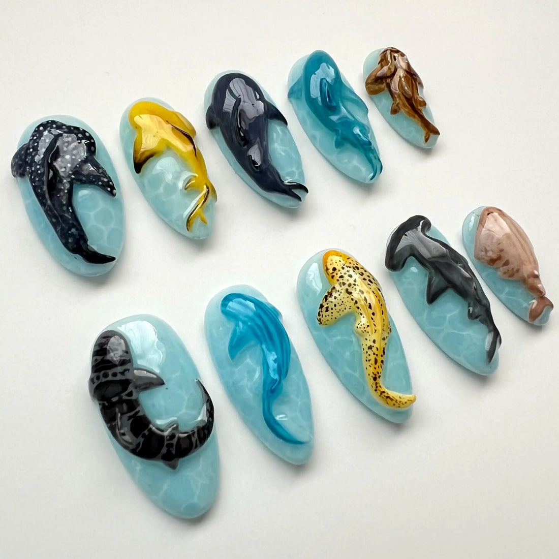 Handmade press-on nails with 3D ocean animal designs including sharks, dolphins, and whales.