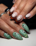 Handmade press-on nails with orange monarch butterfly tips and green beetle nature designs.