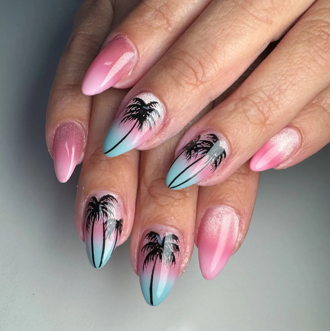 Handmade press-on nails with pink and blue ombre, palm tree design, tropical summer style