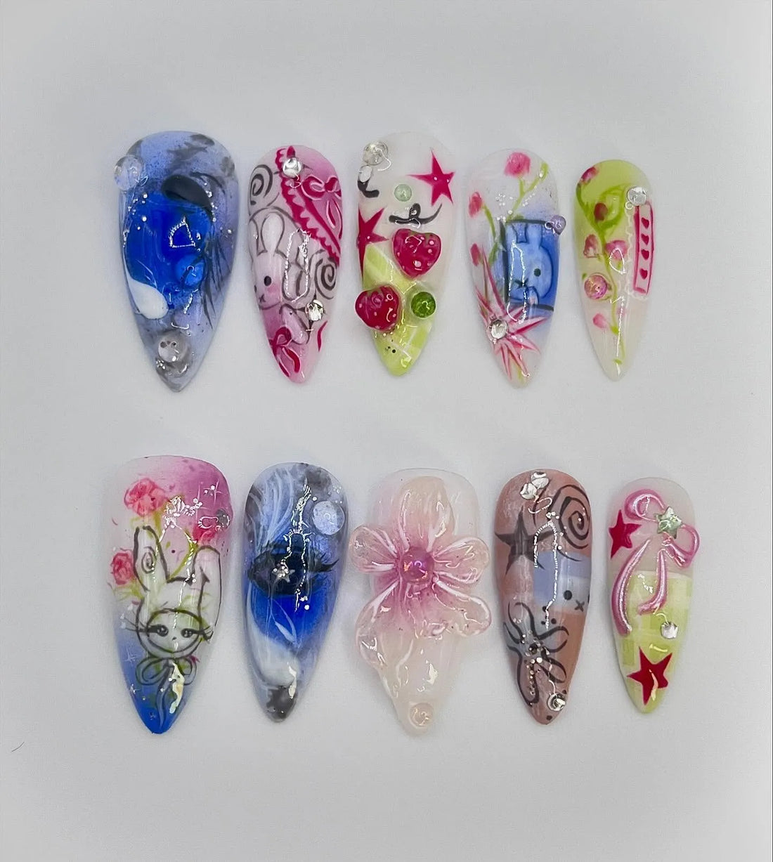 Handmade pastel press-on nails with bunny, stars, hearts, strawberries, and kawaii designs