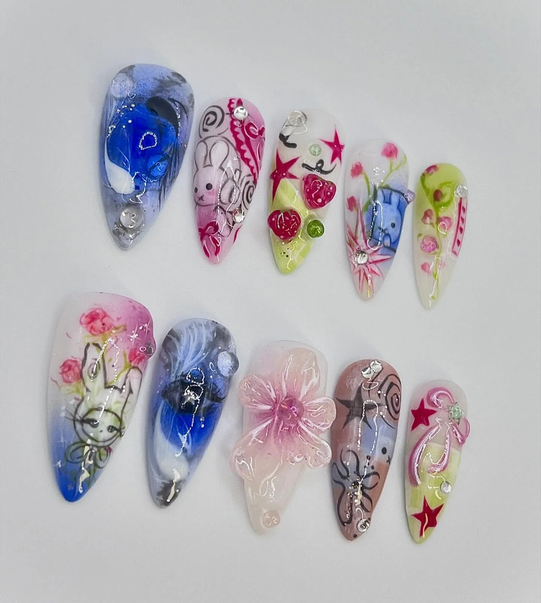 Handmade pastel press-on nails with bunny, stars, hearts, strawberries, and kawaii designs