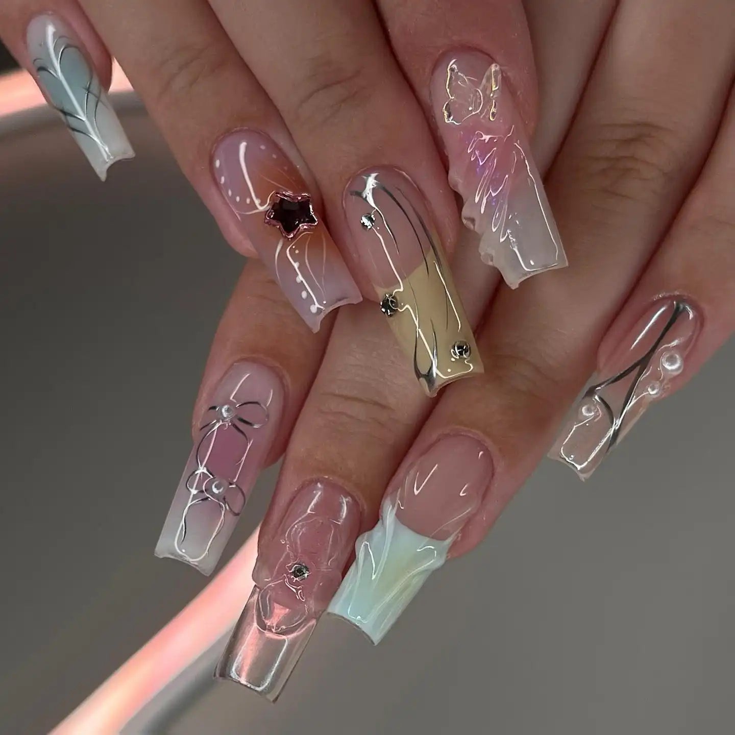 Handmade pastel chrome press-on nails with 3D designs, luxury gel finish, and rhinestone accents