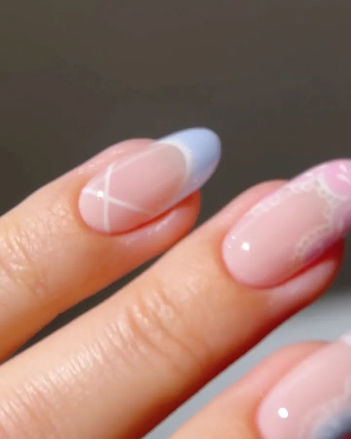 Handmade press-on nails in pastel pink and blue with lace, heart, and bow cottagecore designs