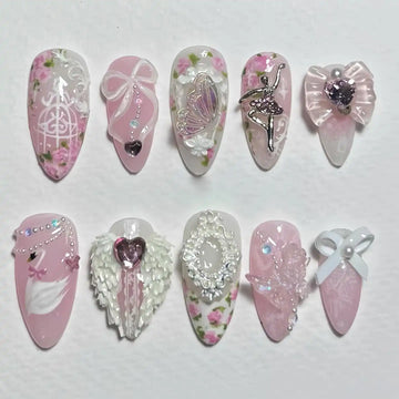 Handmade pink press-on nails with ballerina, swan, butterfly, bows, florals, and 3D accents.