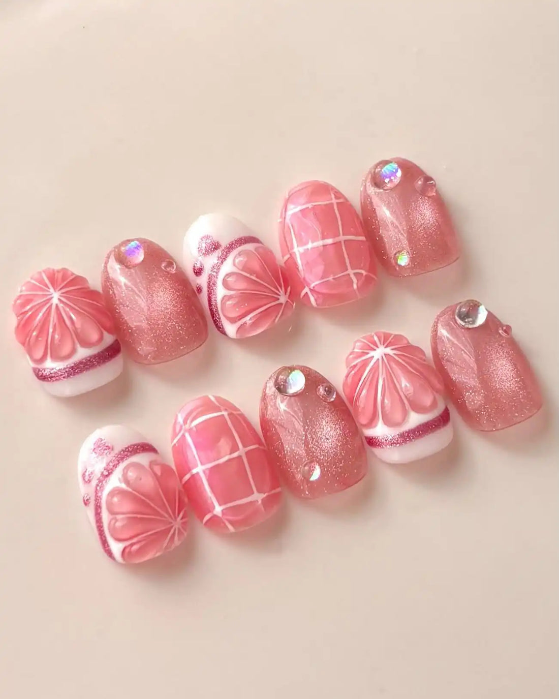 Handmade pink grapefruit citrus 3D press-on nails with shimmer, grid, and rhinestone accents
