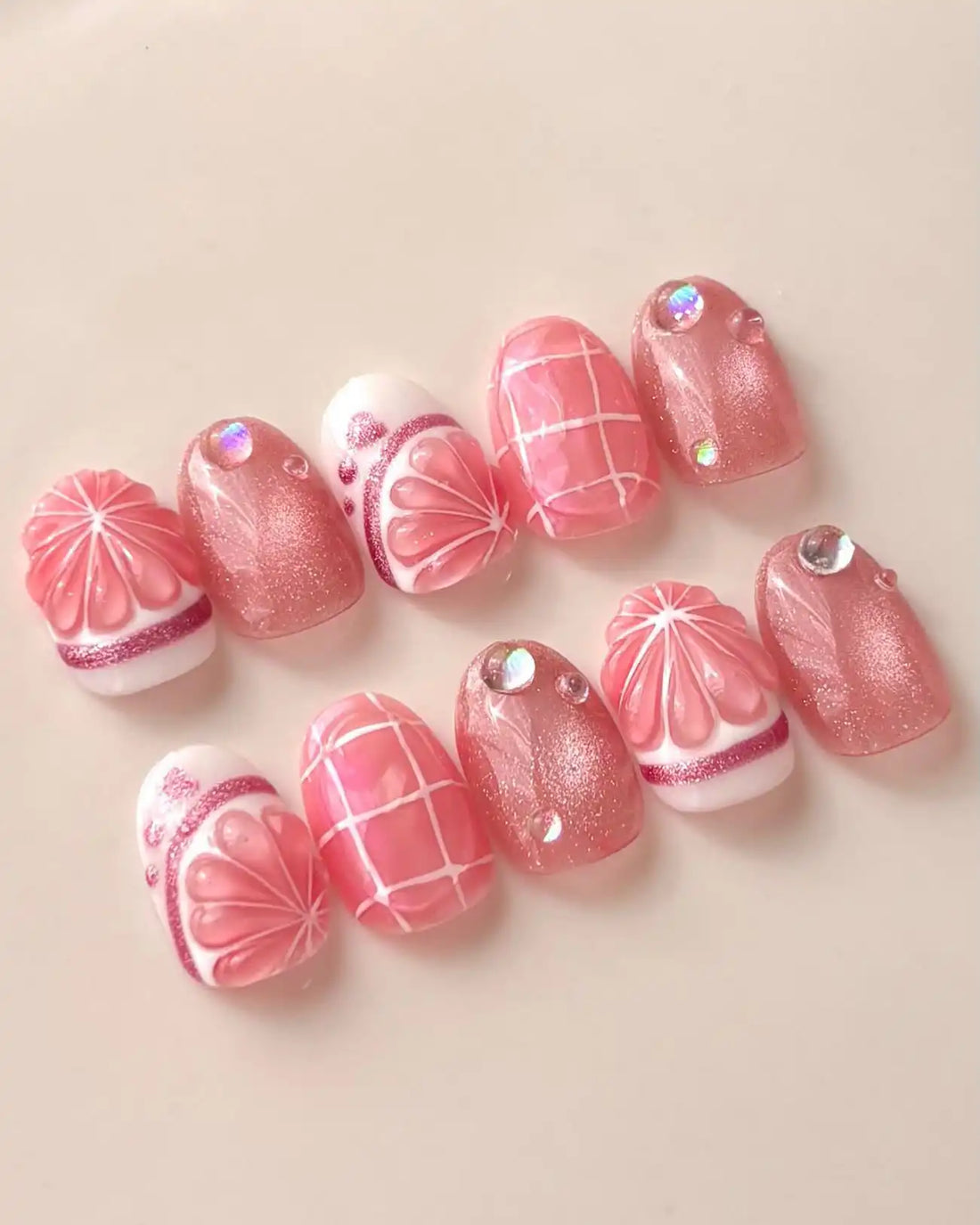 Handmade pink grapefruit citrus 3D press-on nails with shimmer, grid, and rhinestone accents