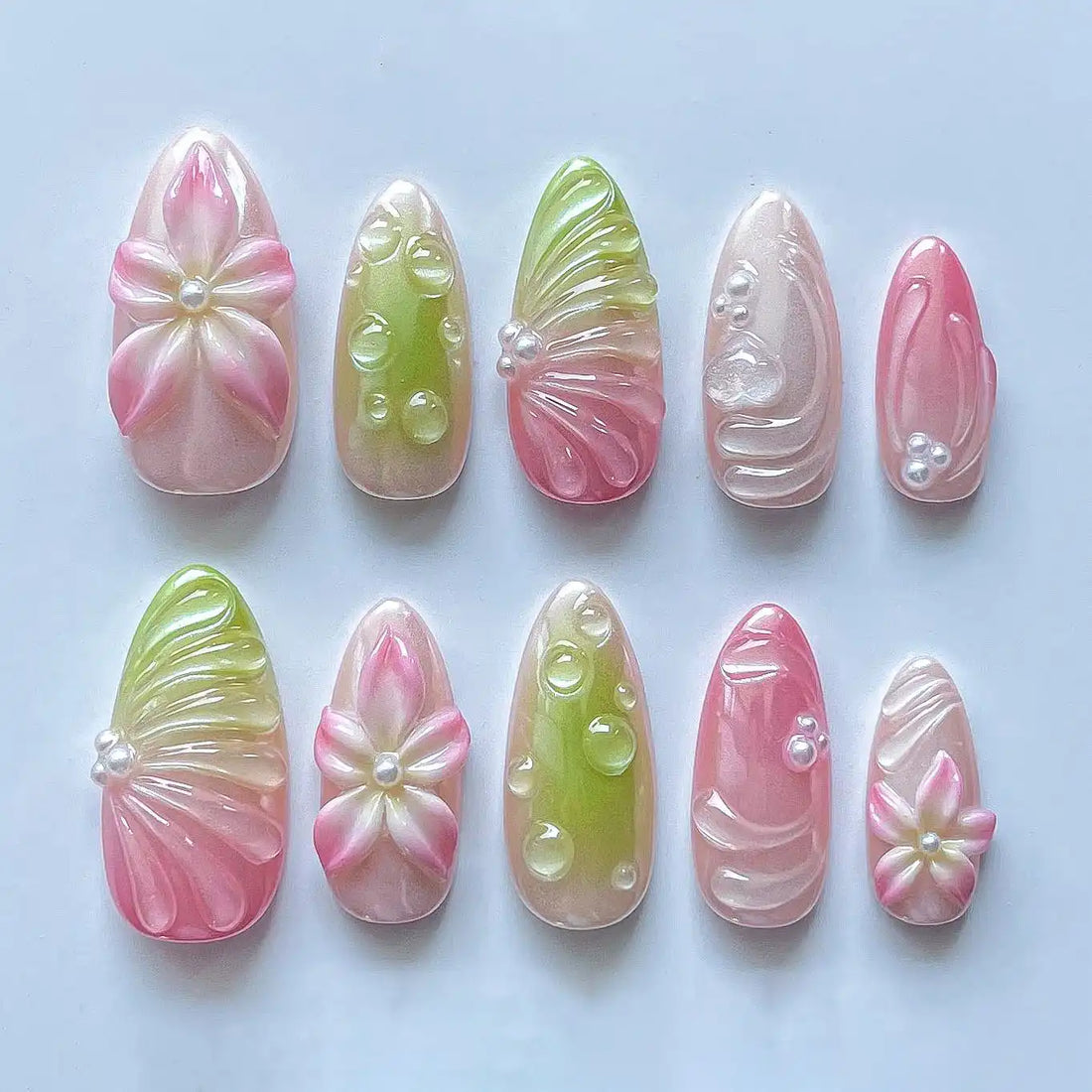 Handmade press-on nails with pink and green flower, pearl, and dew drop spring designs