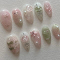 Handmade press-on nails with pink and green Japanese cherry blossom design, pearl accents