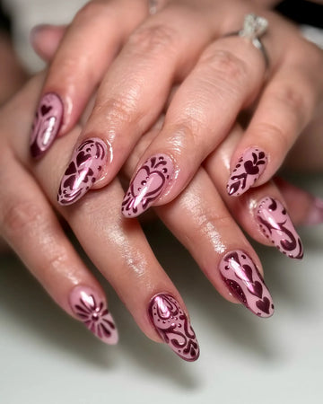 Handmade pink metallic chrome folk art heart press-on nails with intricate designs