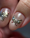 Handmade pink nude press-on nails with 3D butterfly and gemstone pearl accents