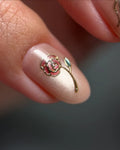 Handmade pink nude press-on nail with gold rose and green leaf art, chic and elegant design