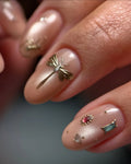 Handmade pink nude press-on nails with gold dragonfly and gemstone accents