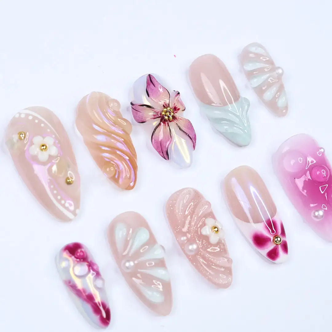 Handmade pink pearl iridescent press-on nails with 3D floral and elegant designs