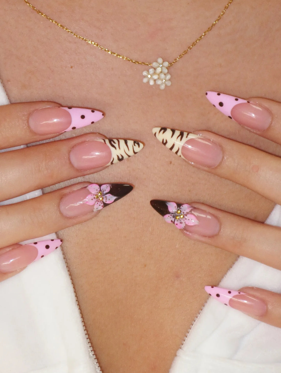 Handmade press-on nails with pink polka dots, animal print, and 3D floral accents.