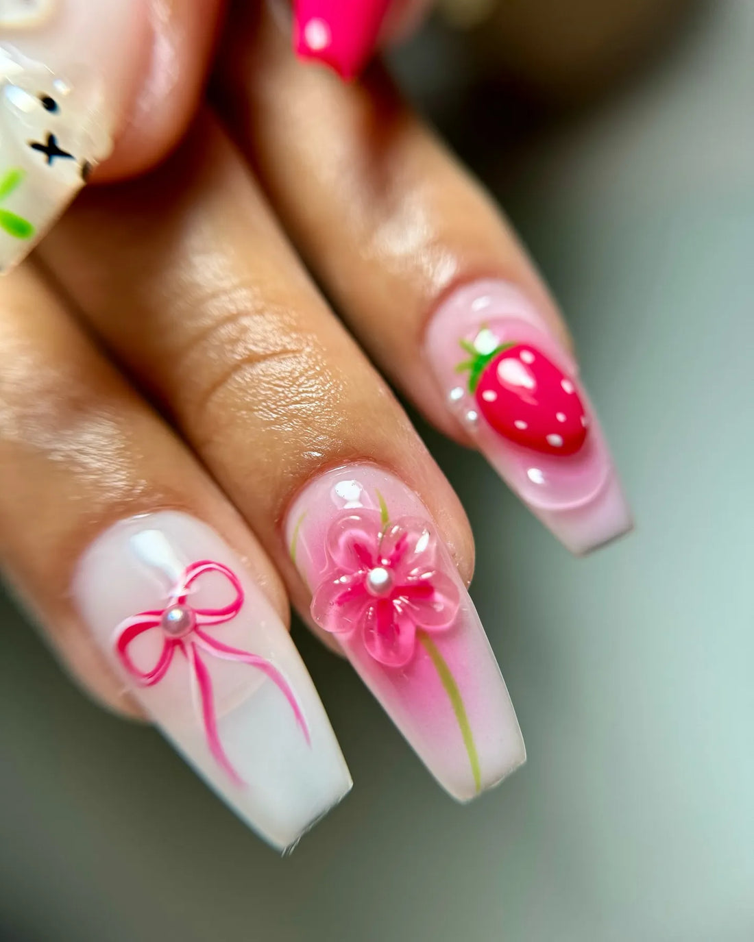 Handmade press-on nails with 3D pink flowers, strawberries, bunny, and bow designs
