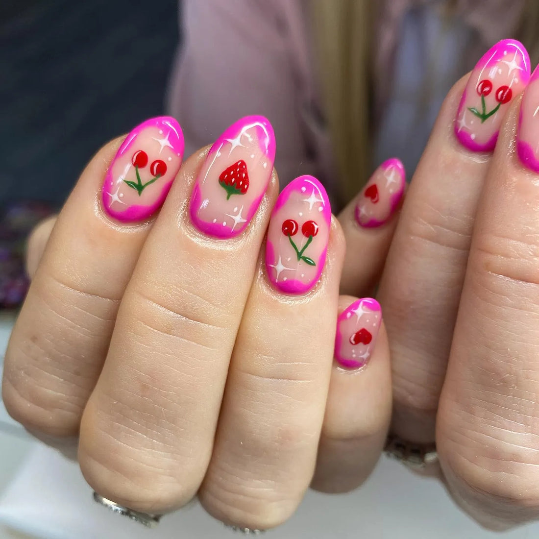 Handmade pink sparkle press-on nails with strawberry and cherry fruit art design