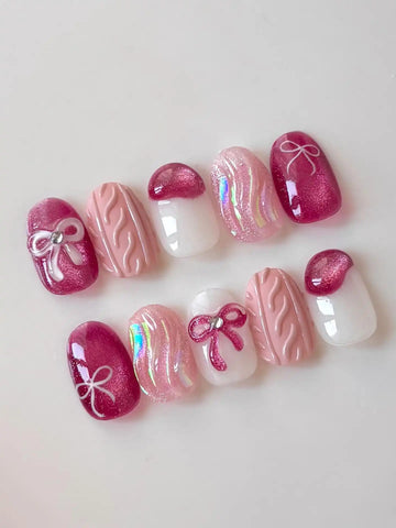 Handmade pink press-on nails with shimmer, bow, ribbon, and knit texture designs