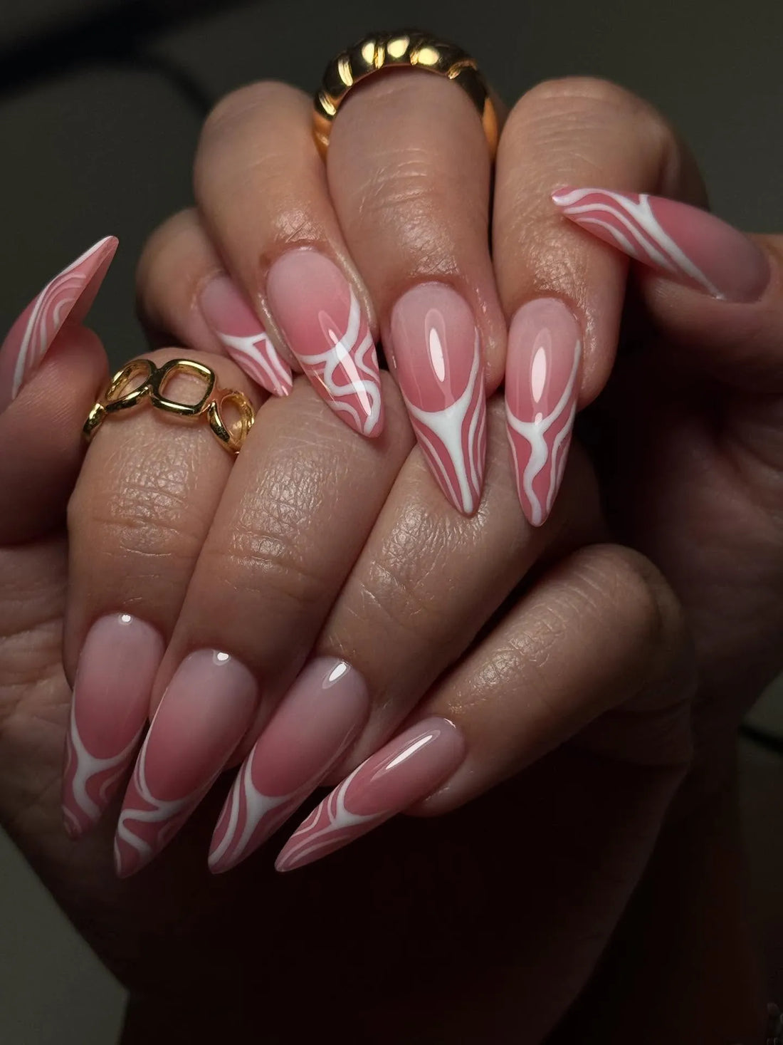 Handmade pink swirl abstract French tip press-on nails with Y2K aesthetic on almond shape