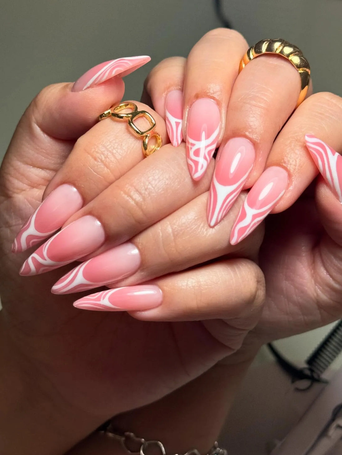 Handmade pink swirl abstract French tip press-on nails with Y2K aesthetic on almond shape