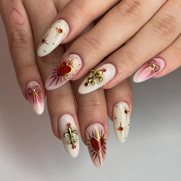 Handmade press-on nails with gold fleur-de-lis, red heart, and bow art accents