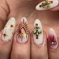 Handmade press-on nails with gold fleur-de-lis, red rhinestones, sacred heart and bow designs.